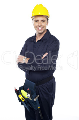 Smiling young craftsman with tool pouch around his waist