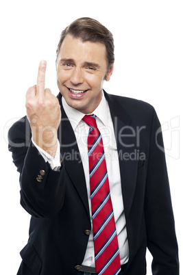 Displeased businessman showing middle finger politely
