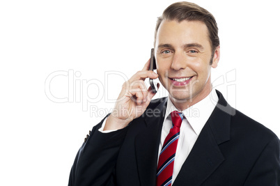 Corporate male consultant talking over cellphone