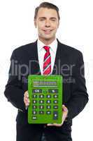 Young businessman showing big green calculator