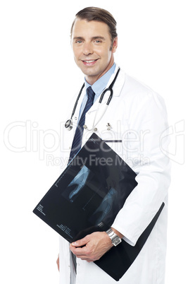 Smart surgeon holding x-ray report of a patient