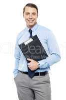 Handsome smiling executive holding clipboard