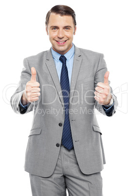 Handsome executive showing double thumbs up