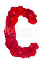 Letter C made from red petals rose on white