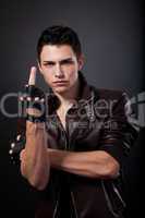 Angry handsome young man is showing a middle finger