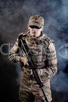 Soldier with a rifle on a black background
