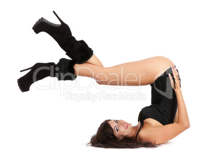 Sexy woman practicing yoga. Wears beautiful boots