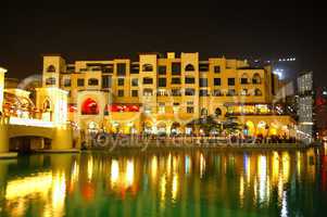 Buildings in Dubai Downtown and man-made lake in night illuminat