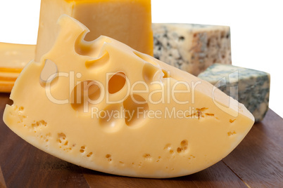 Different types of cheese on wooden table