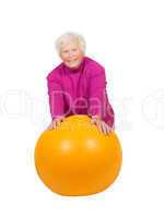 Cheerful retired lady with a pilates ball