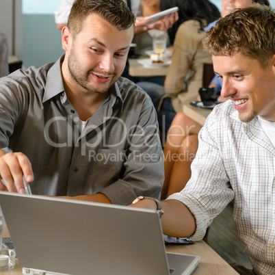 Men business partners working on laptop cafe
