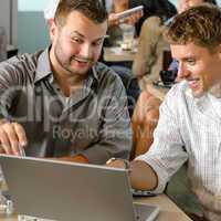 Men business partners working on laptop cafe