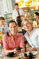 Mother and daughter relaxing in a cafe