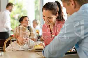 Mother and father with child eating cake