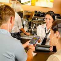 Man paying with credit card at cafe