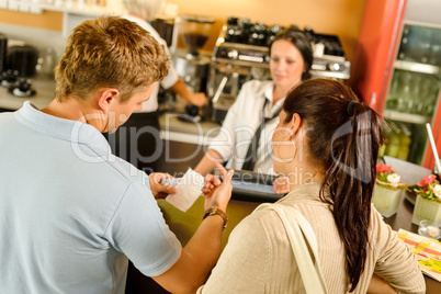 Man checking receipt at cafe payment
