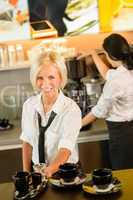 Waitress serving coffee cups making espresso woman