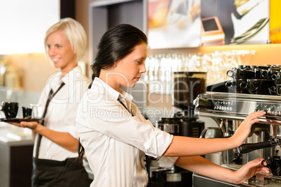 Staff at cafe making coffee espresso machine