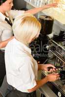 Waitresses at work make coffee machine cafe