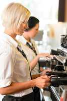 Waitresses at work make coffee machine cafe
