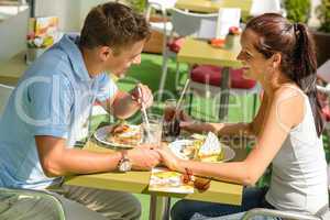 Couple holding hands flirting at cafe happy