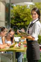 Waitress waiting for clients to decide order