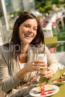 Woman at cafe bar holding latte drink