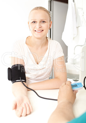 Girl is checking her blood pressure pressure.