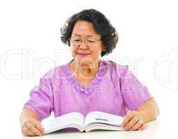 Asian senior woman serious reading