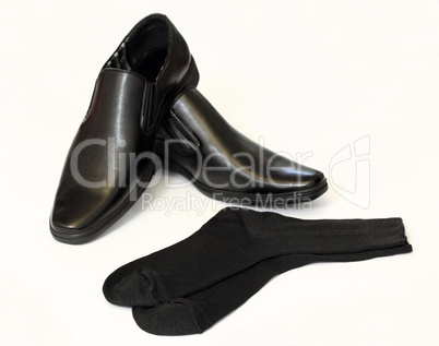man's black shoes and socks isolated on white background