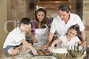 Attractive Family Baking and Eating Cookies In A Kitchen