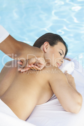 Woman Having Massage By Pool At Health Spa