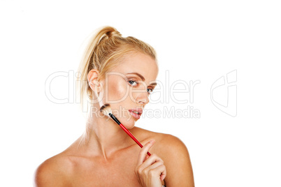Beautiful woman with cosmetics brush