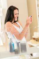 Happy woman looking at pregnancy test result