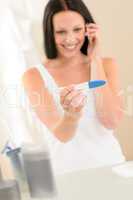 Happy woman positive pregnancy test result