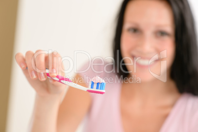 Toothpaste on toothbrush close-up teeth brushing
