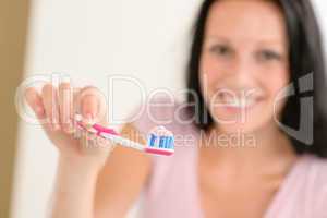 Toothpaste on toothbrush close-up teeth brushing