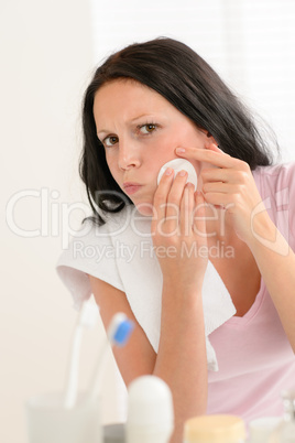 Woman squeezing pimple cleaning acne skin