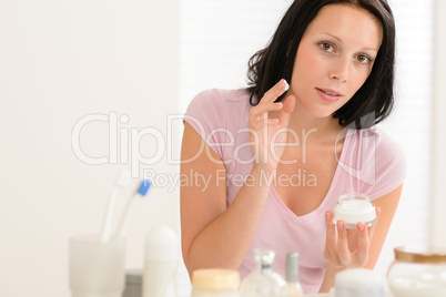 Beauty woman put moisturizer cream in bathroom