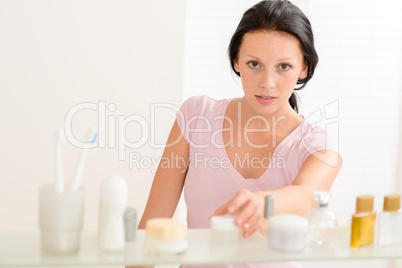 Young woman take beauty care product