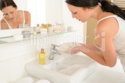 Woman bathroom hand-wash with soap above sink