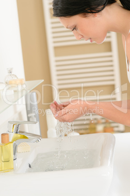 Woman wash face at basin bathroom