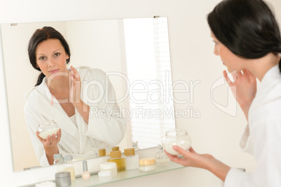 Woman facial mirror reflection in bathroom