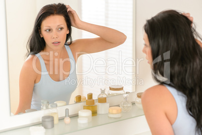 Woman look at herself bathroom mirror reflection