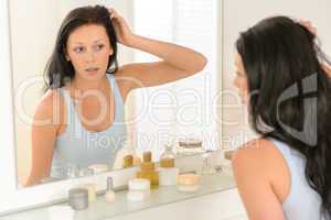 Woman look at herself bathroom mirror reflection