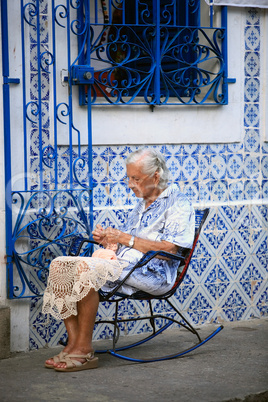 old woman sewing