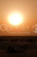 romantic couple looking at the sunset at khuri dunes in thar desert near jaisalmer in rajasthan state in india