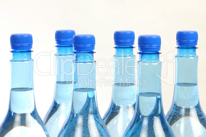 close up of gas water bottles on a white background