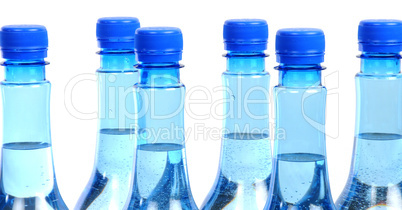 close up of gas water bottles on a white background