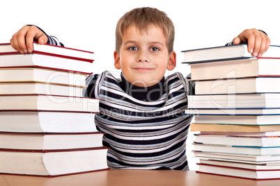 Schoolboy and a heap of books isolated on a white background